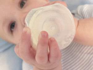 Infant drinking from a bottle