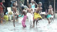 Happy kids dancing in the rain