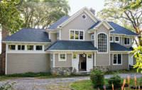 A large house with asphalt shingles on the roof.