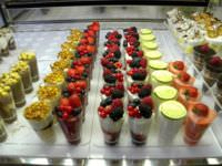 Gelato cups with various toppings in Italy.