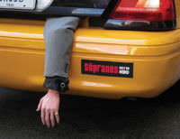 An ad for the TV series The Sopranos, which is about the mafia. The ad is in the form of what looks like a human arm dangling out of a taxi's trunk.